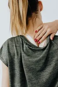 back view of a woman having a neck pain