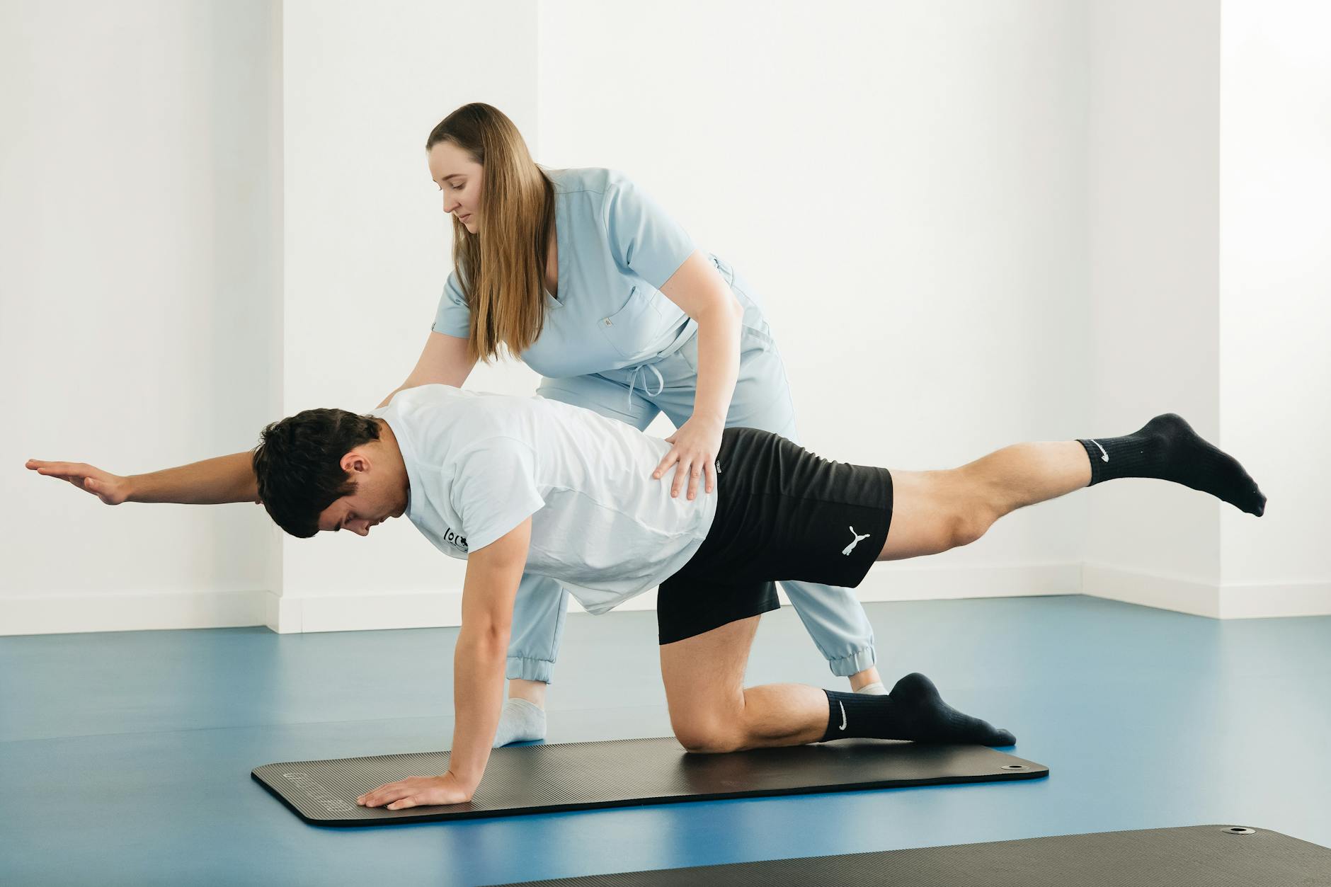 physiotherapist exercising with a patient